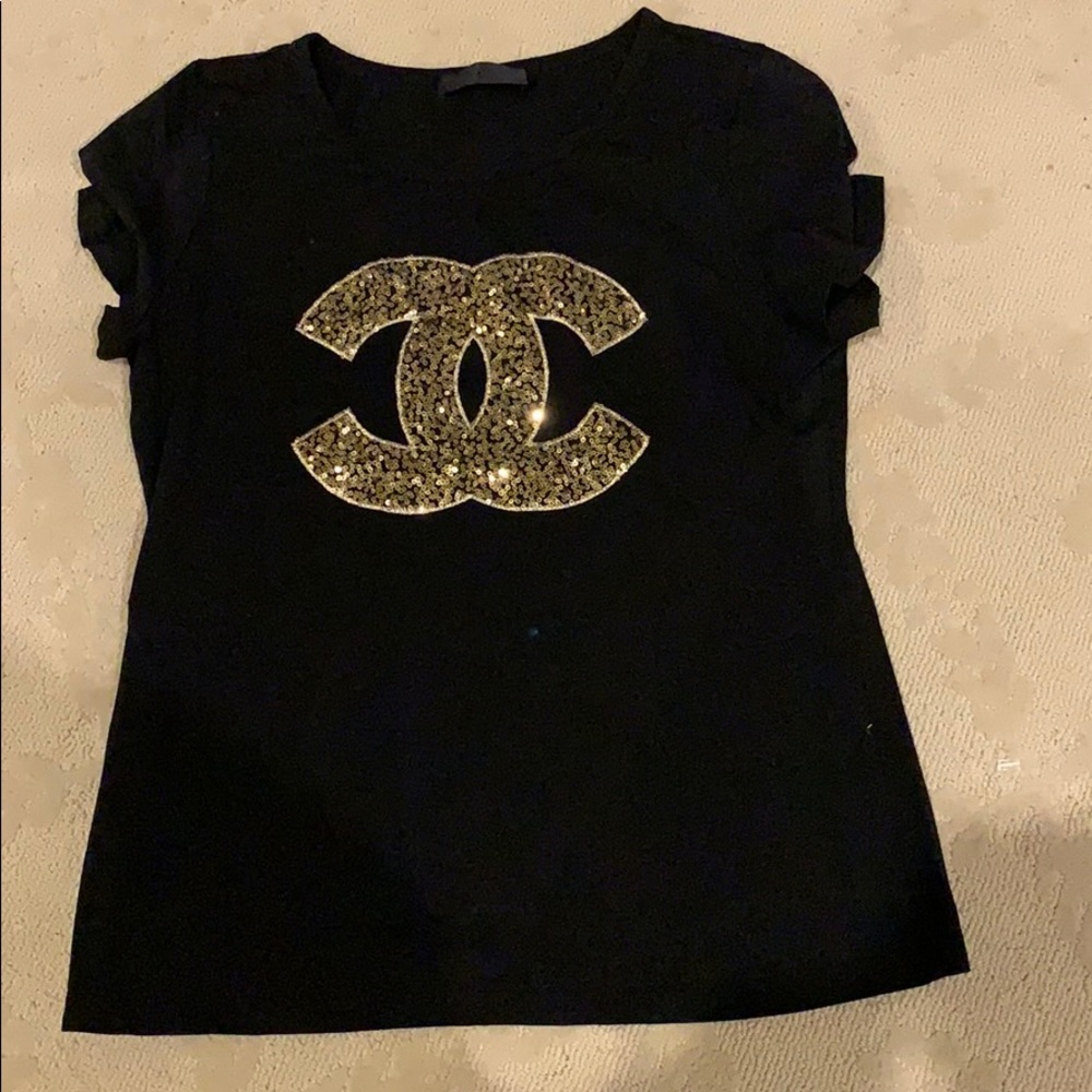 Women’s black and gold Chanel T-shirt.